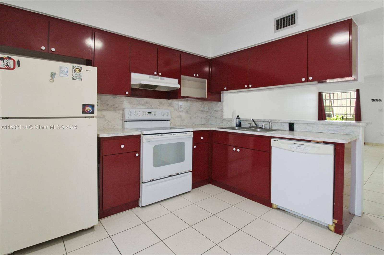 937 Michigan Avenue, Unit 4 Miami Beach, FL 33139 - Photo 5 of 20 a kitchen with a sink a stove and cabinets