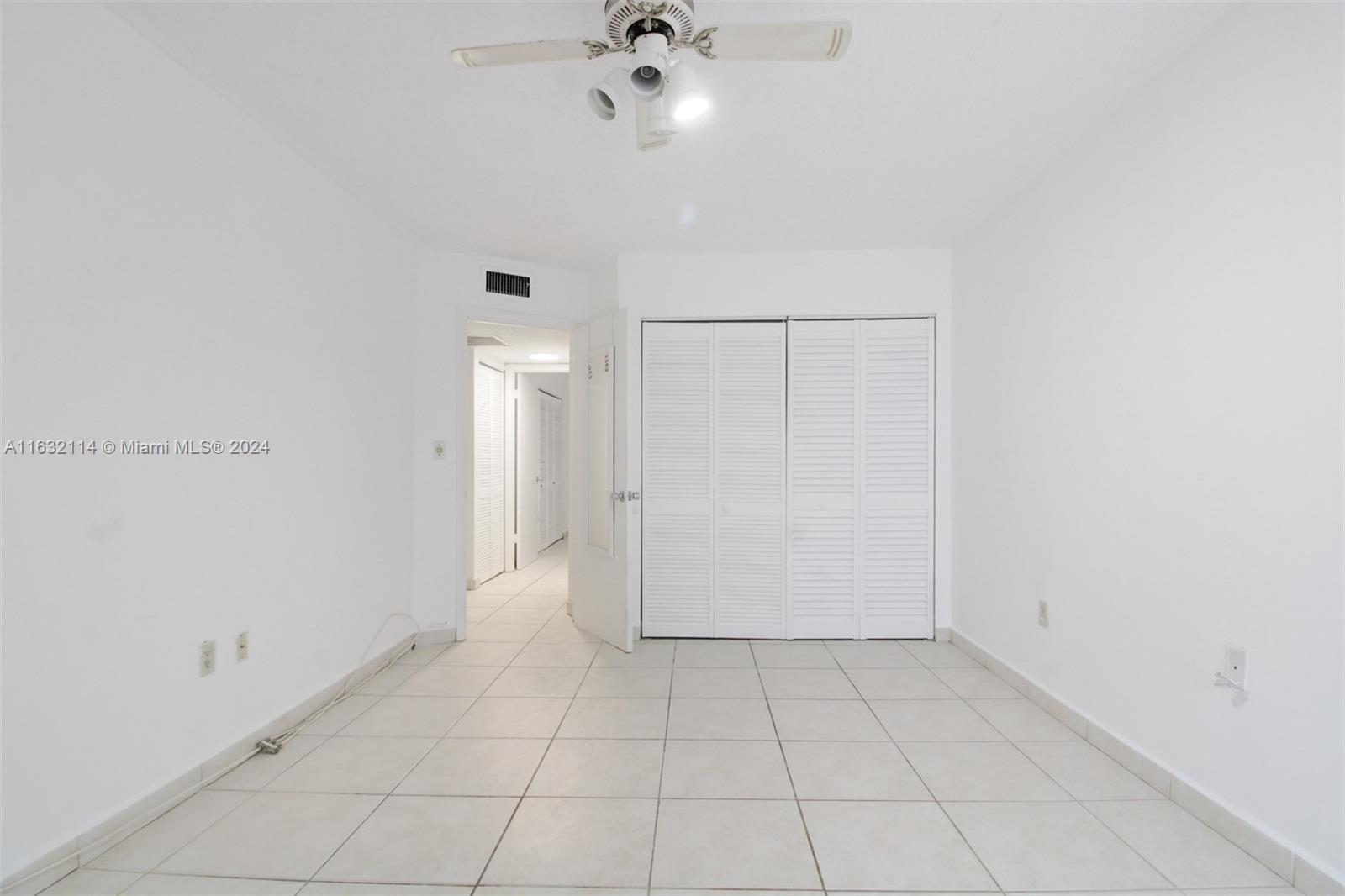 937 Michigan Avenue, Unit 4 Miami Beach, FL 33139 - Photo 6 of 20 an empty room with white walls and ceiling fan
