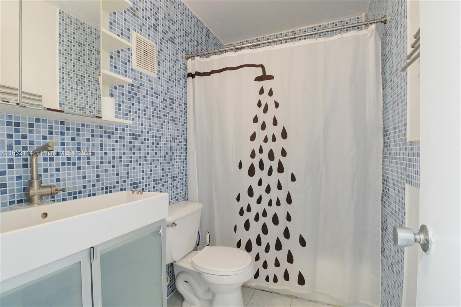 937 Michigan Avenue, Unit 4 Miami Beach, FL 33139 - Photo 8 of 20 a bathroom with a toilet a sink and a shower