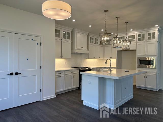 2 Aster Circle Old Bridge, NJ 08857 - Photo 11 of 60 a kitchen with kitchen island granite countertop a sink cabinets and wooden floor