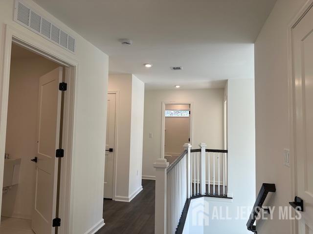 2 Aster Circle Old Bridge, NJ 08857 - Photo 47 of 60 a view of a hallway to a room with wooden floor and stairs