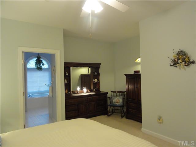 3425 Savan Court Raleigh, NC 27613 - Photo 13 of 25 a bedroom with a bed and a dresser in it