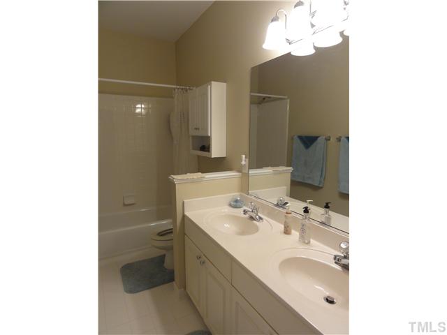 3425 Savan Court Raleigh, NC 27613 - Photo 18 of 25 a bathroom with a sink a toilet and a mirror