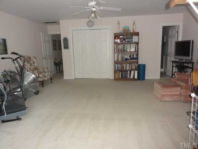 3425 Savan Court Raleigh, NC 27613 - Photo 20 of 25 a view of a livingroom with furniture and a flat screen tv