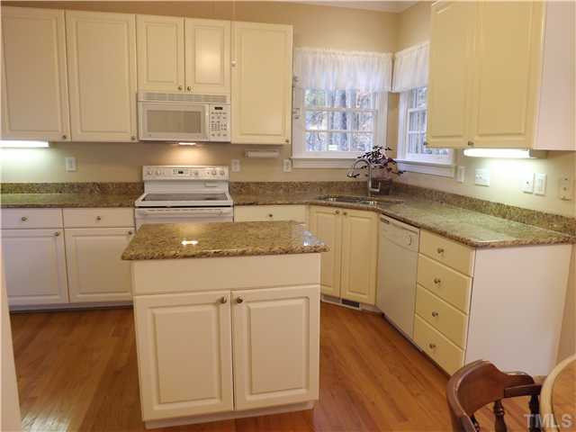 3425 Savan Court Raleigh, NC 27613 - Photo 9 of 25 a kitchen with stainless steel appliances granite countertop a sink a stove and cabinets