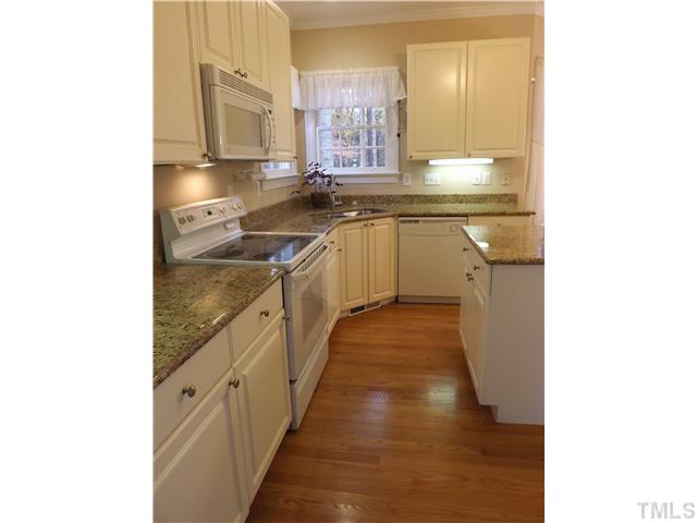 3425 Savan Court Raleigh, NC 27613 - Photo 10 of 25 a kitchen with stainless steel appliances granite countertop a sink and cabinets