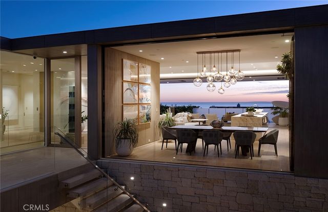 a kitchen with a sink a cabinets and chairs
