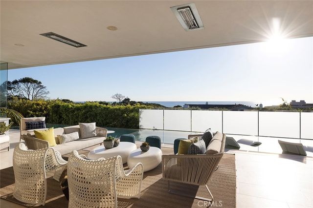 a living room with furniture flowerpot and wooden floor