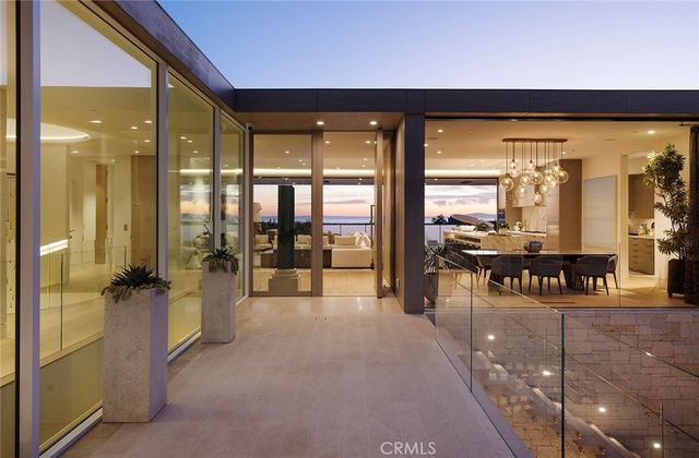 a living room with lots of white furniture and a large window