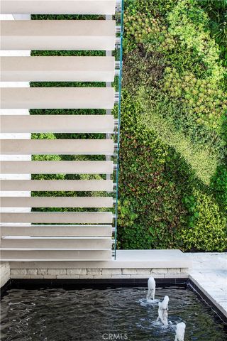 a living room with stainless steel appliances kitchen island granite countertop furniture and a large window