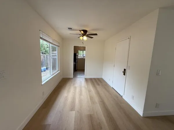 wooden floor in an empty room with a window