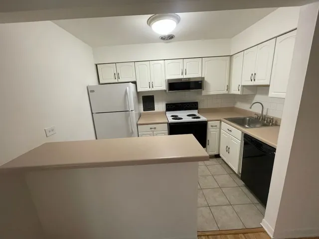 a kitchen with stainless steel appliances a refrigerator stove microwave and sink