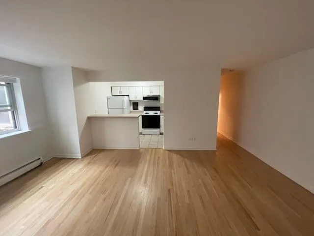 a view of a kitchen with wooden floor