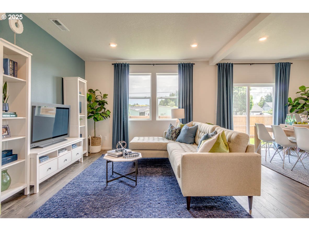 2996 U Street Springfield, OR 97477 - Photo 4 of 21 a living room with furniture and a flat screen tv