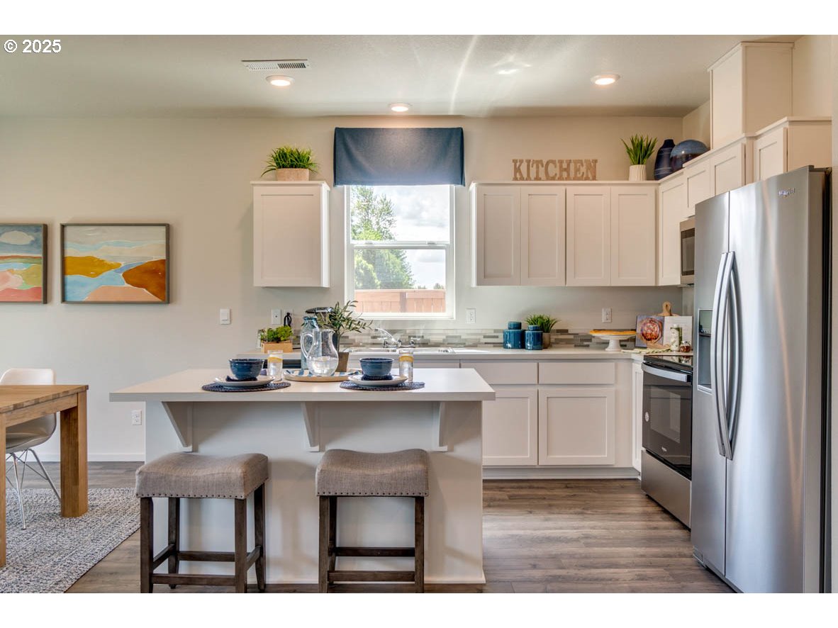 2996 U Street Springfield, OR 97477 - Photo 7 of 21 a kitchen with a sink cabinets and refrigerator