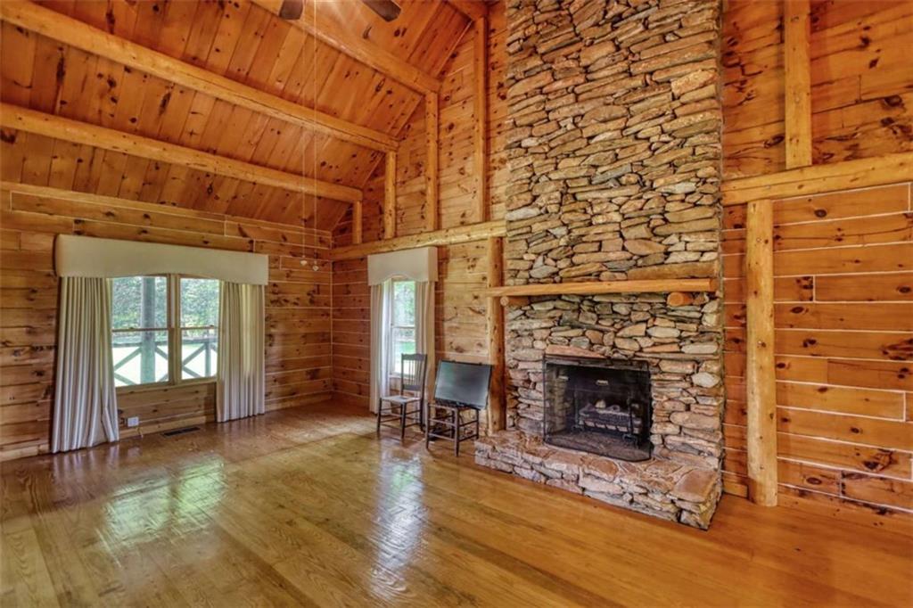 2665 Macedonia Road Franklin, GA 30217 - Photo 22 of 68 a living room with a fireplace and a wooden floor