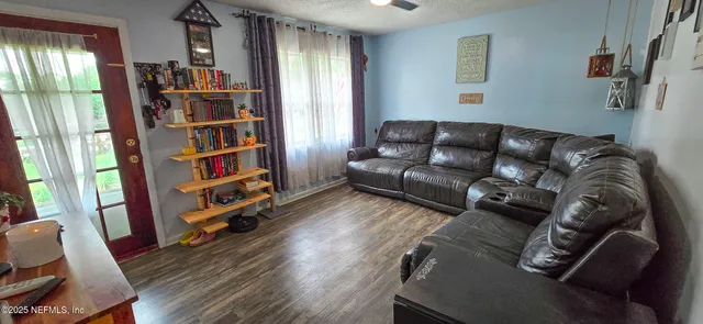 a living room with furniture and a book shelf