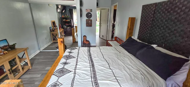 a walk in closet with clothes and shoes