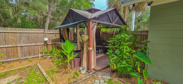 a view of a house with roof deck and wooden floor