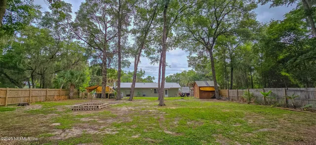 a view of a park with large trees
