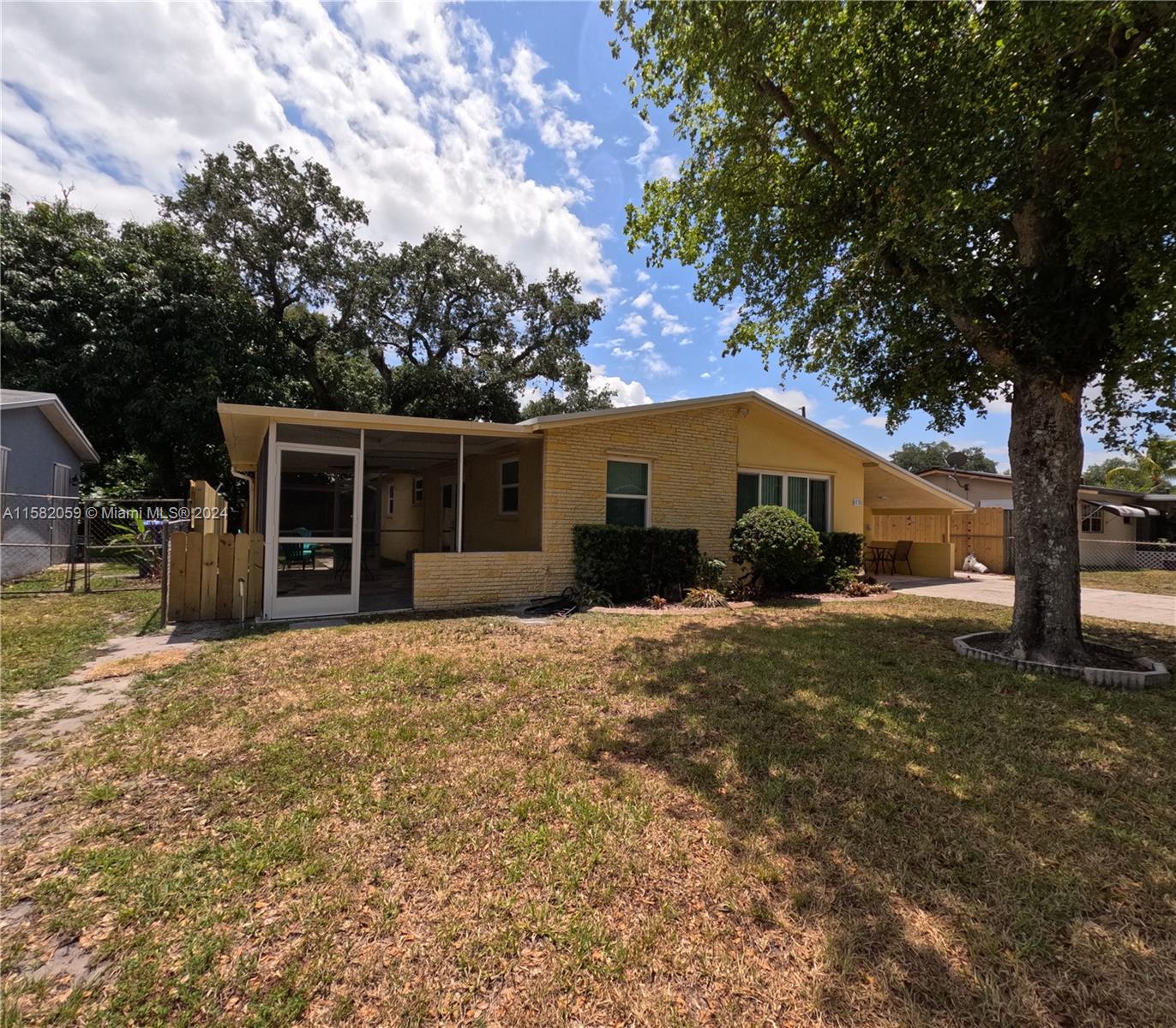 a front view of house with yard and trees in the background