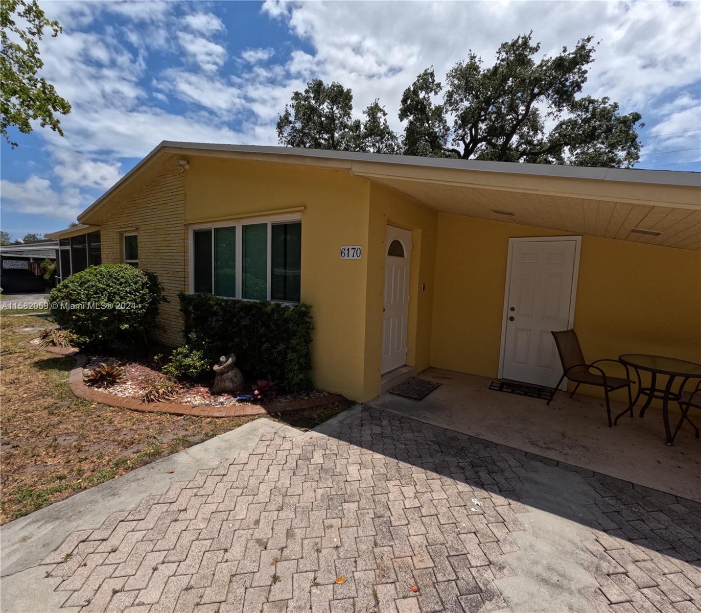 6170 Harding Street, Unit F Hollywood, FL 33024 - Photo 2 of 17 a house view with a garden space