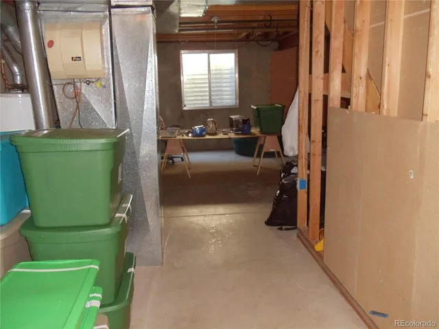 a view of a kitchen with fridge and front door