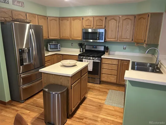 a kitchen with a sink stove and refrigerator