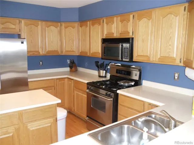 a kitchen with a stove a sink and a microwave