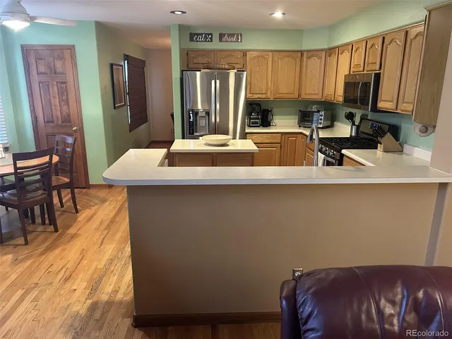 a kitchen with a table chairs refrigerator and sink