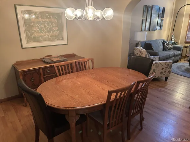 a view of a dining room with furniture and wooden floor