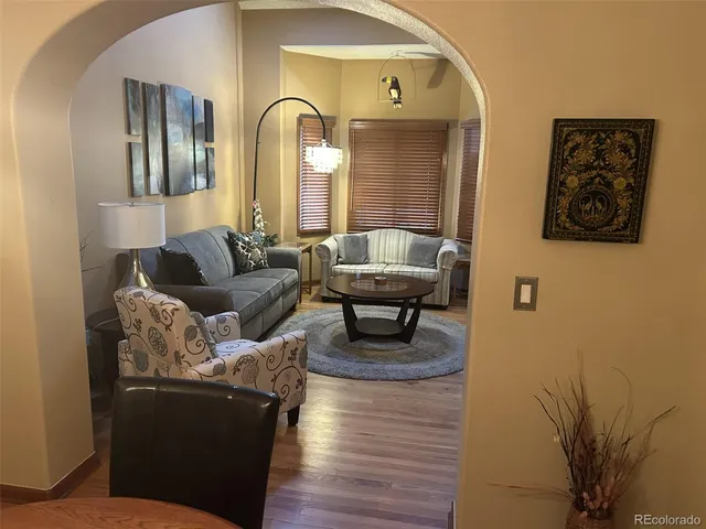 a living room with furniture and a potted plant