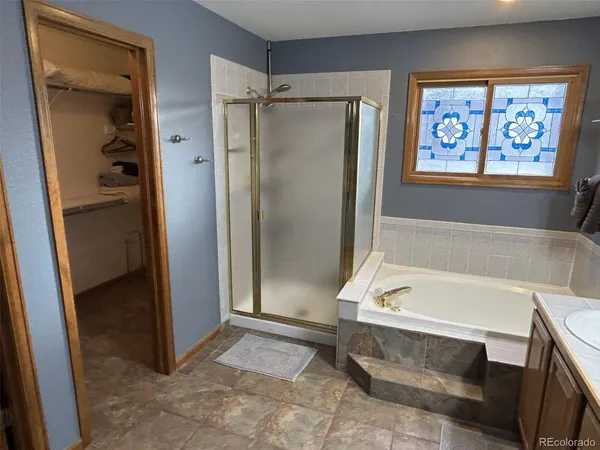 a bathroom with a double vanity sink tub and a mirror