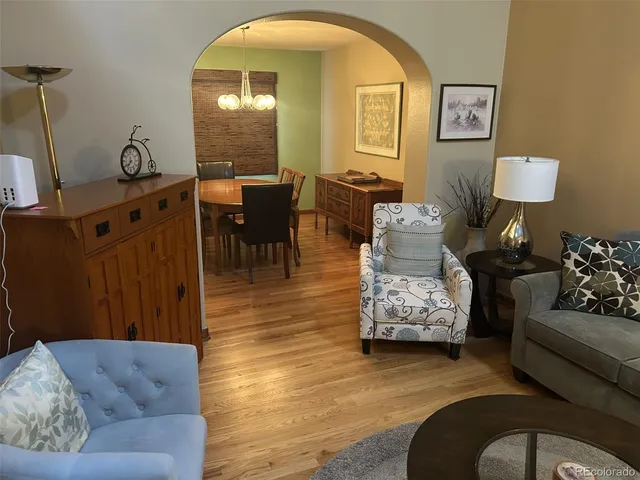 a living room with furniture and a mirror