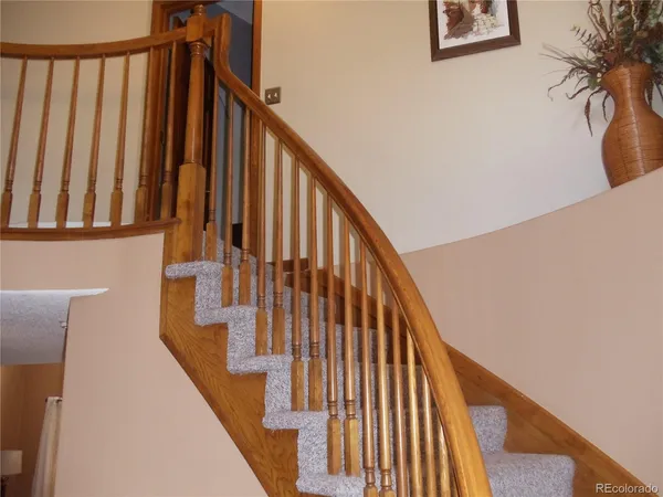 a view of staircase with wooden floor and a window