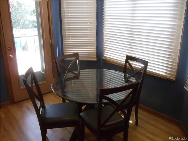 a view of a dining room with furniture and wooden floor