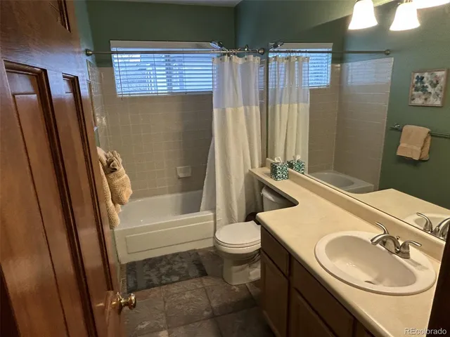 a bedroom with a bed wooden floor and a window