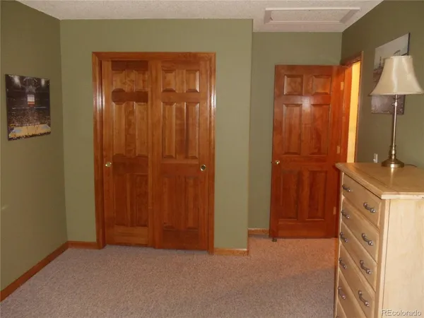 a bedroom with a bed and a mirror