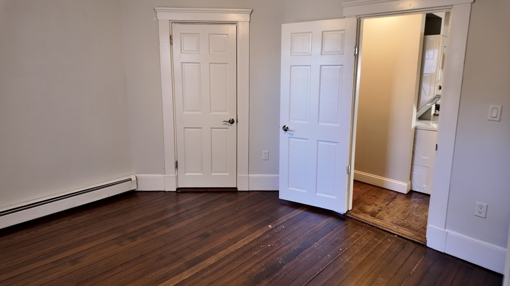 294 Windsor Street, Unit 2 Cambridge, MA 02139 - Photo 5 of 13 a view of an empty room with wooden floor and a window