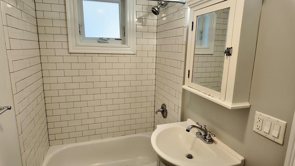 294 Windsor Street, Unit 2 Cambridge, MA 02139 - Photo 8 of 13 a bathroom with a sink a toilet and shower