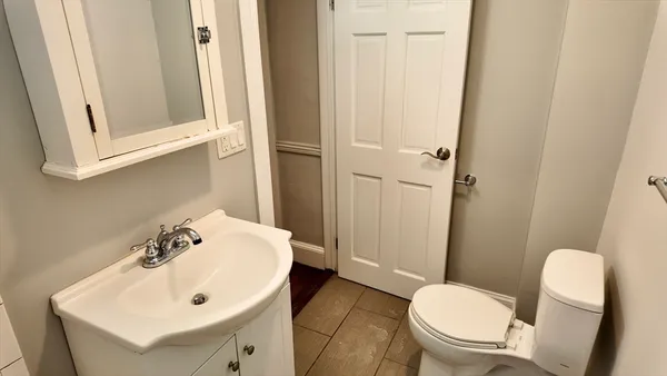 a white toilet sitting next to a bathroom sink