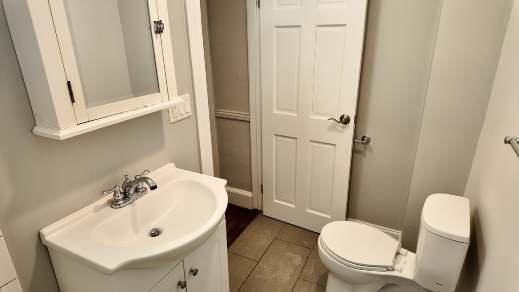 294 Windsor Street, Unit 2 Cambridge, MA 02139 - Photo 9 of 13 a white toilet sitting next to a bathroom sink