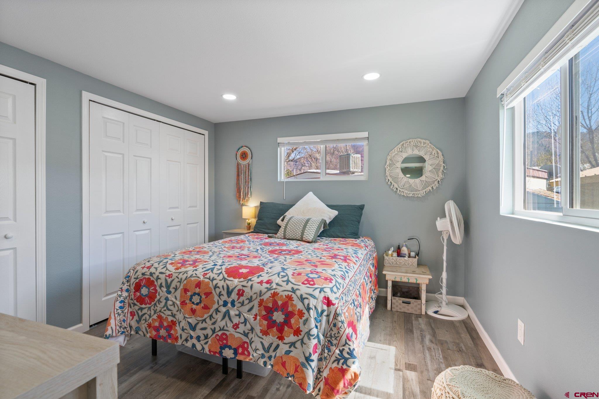 31722 Highway 550, Unit 55 Durango, CO 81301 - Photo 12 of 20 a bedroom with a bed and wooden floor
