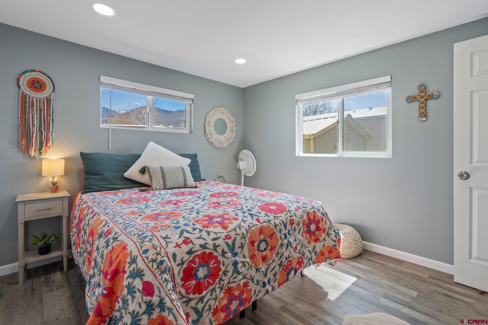31722 Highway 550, Unit 55 Durango, CO 81301 - Photo 13 of 20 a bedroom with bed and wall painting with wooden floor