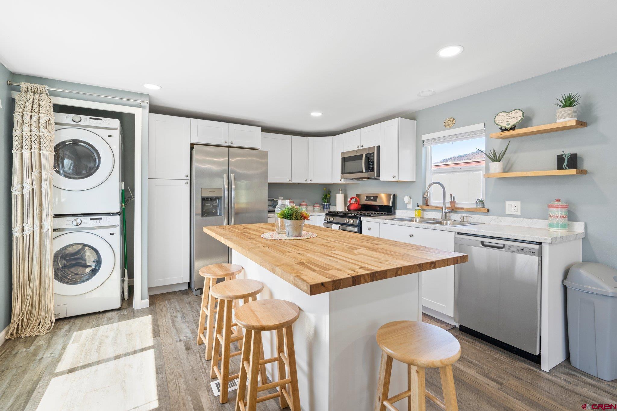 31722 Highway 550, Unit 55 Durango, CO 81301 - Photo 4 of 20 a kitchen with a stove a sink and a refrigerator