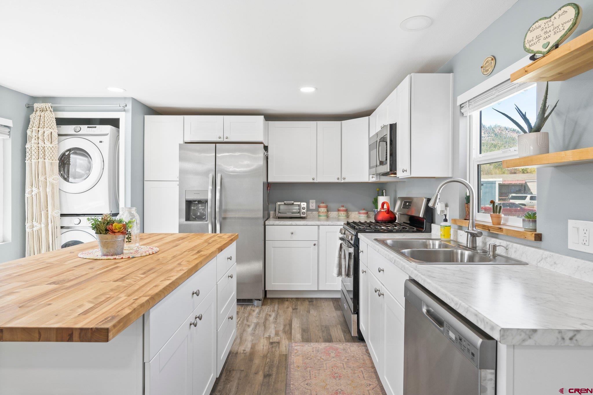 31722 Highway 550, Unit 55 Durango, CO 81301 - Photo 7 of 20 a kitchen with granite countertop a sink stove and cabinets