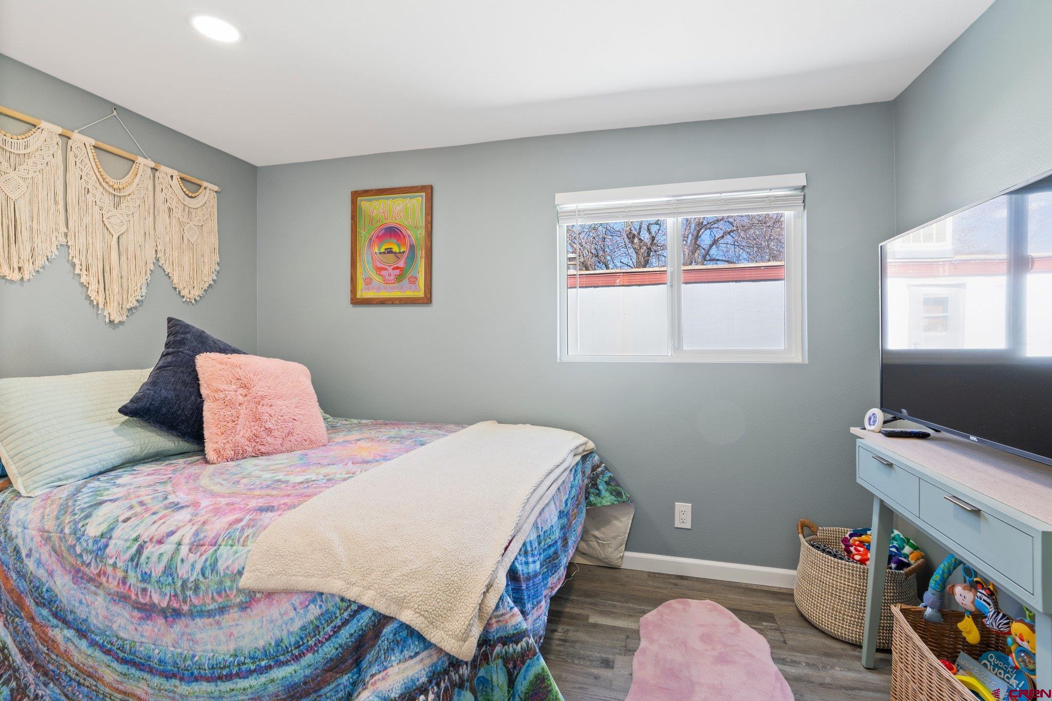 31722 Highway 550, Unit 55 Durango, CO 81301 - Photo 10 of 20 a bedroom with a bed a dresser and a window