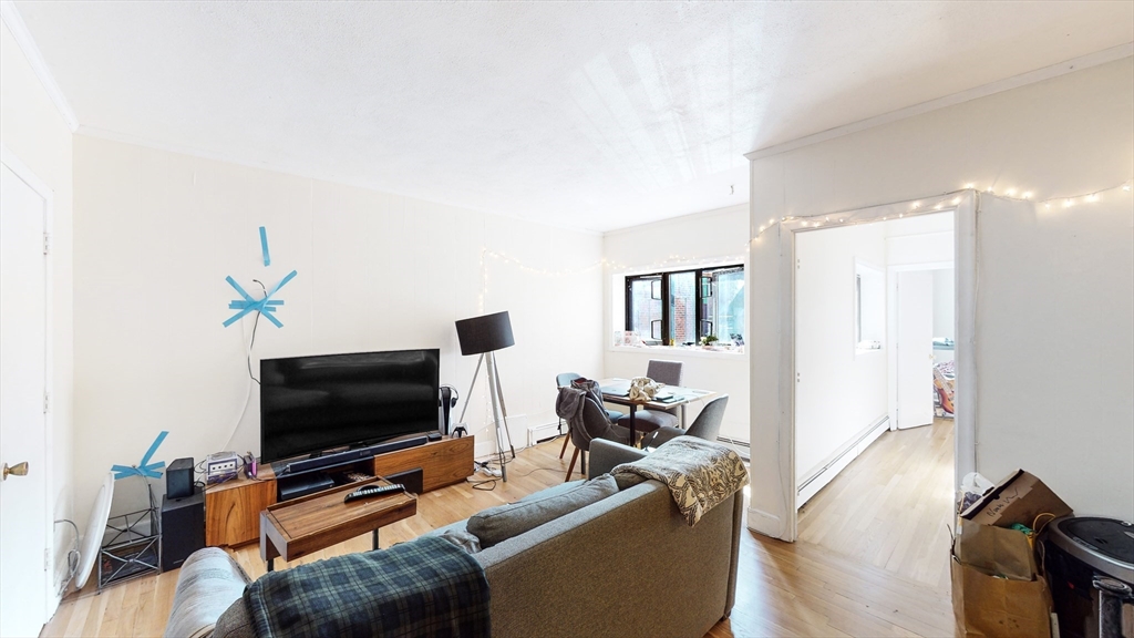 513 Beacon Street, Unit 6 Boston, MA 02215 - Photo 1 of 8 a living room with furniture and a flat screen tv