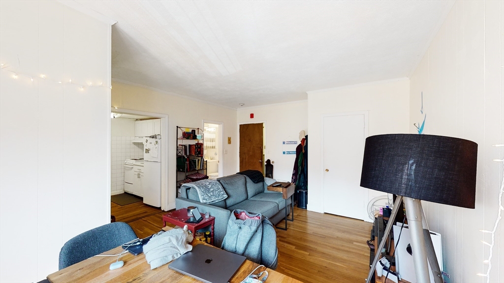 513 Beacon Street, Unit 6 Boston, MA 02215 - Photo 3 of 8 a living room with furniture and wooden floor