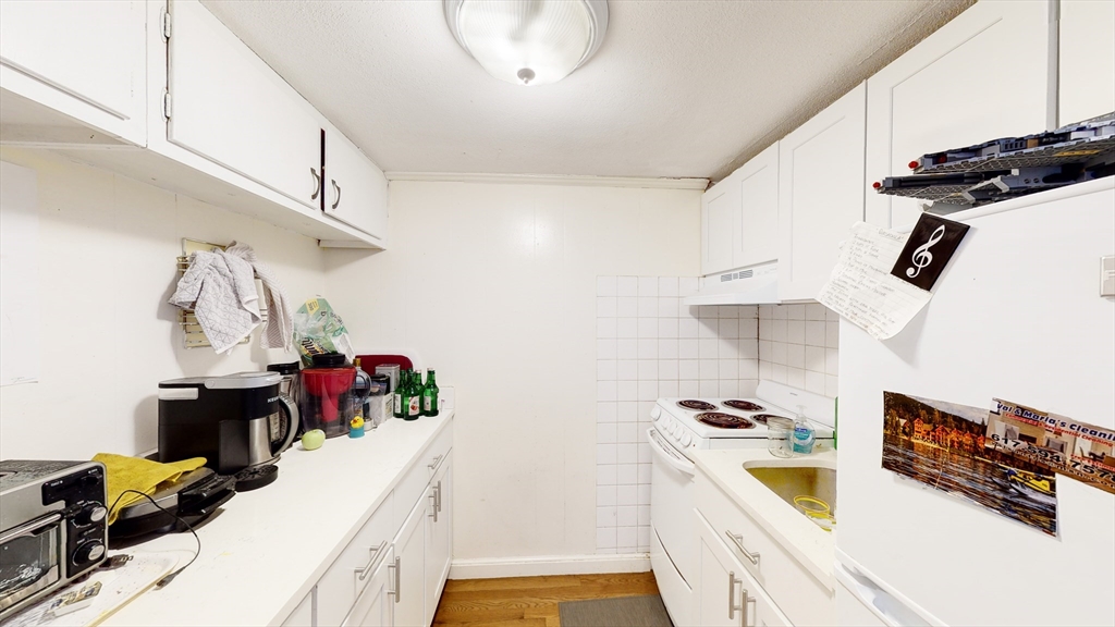513 Beacon Street, Unit 6 Boston, MA 02215 - Photo 4 of 8 a kitchen with sink cabinets and appliances